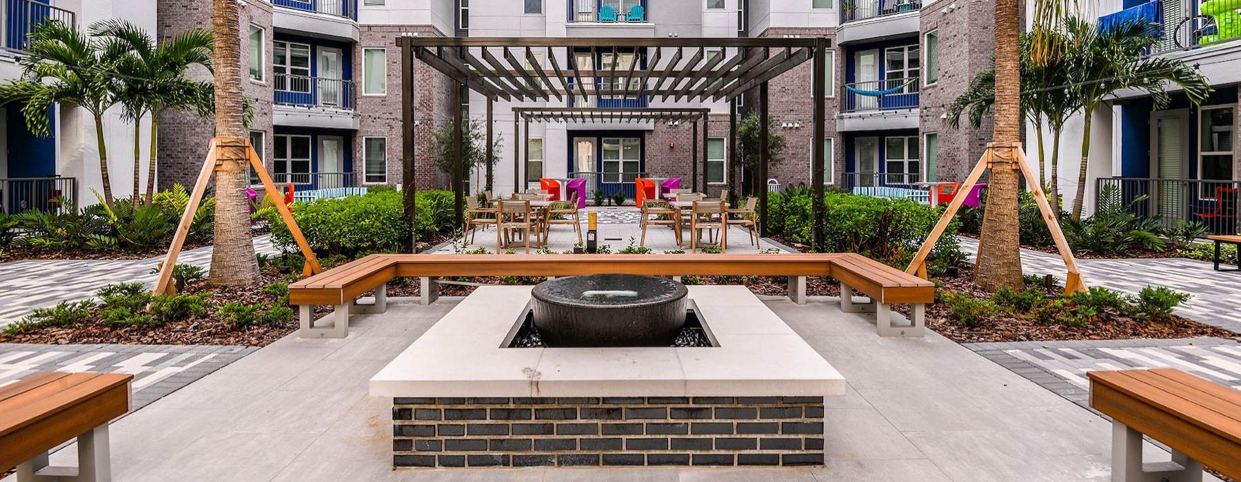 courtyard with benches around fire pit