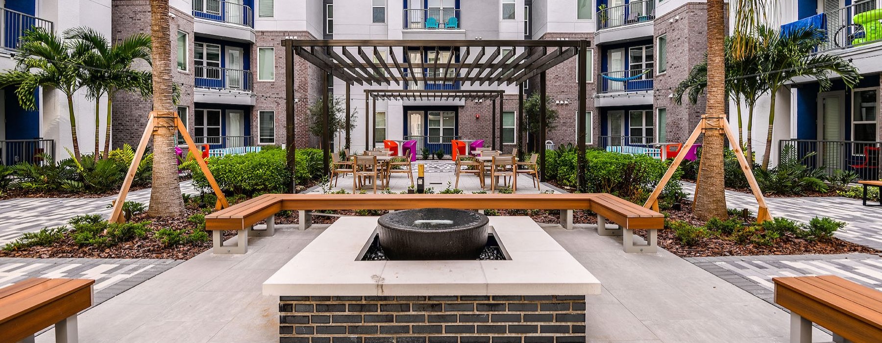 courtyard with benches around fire pit