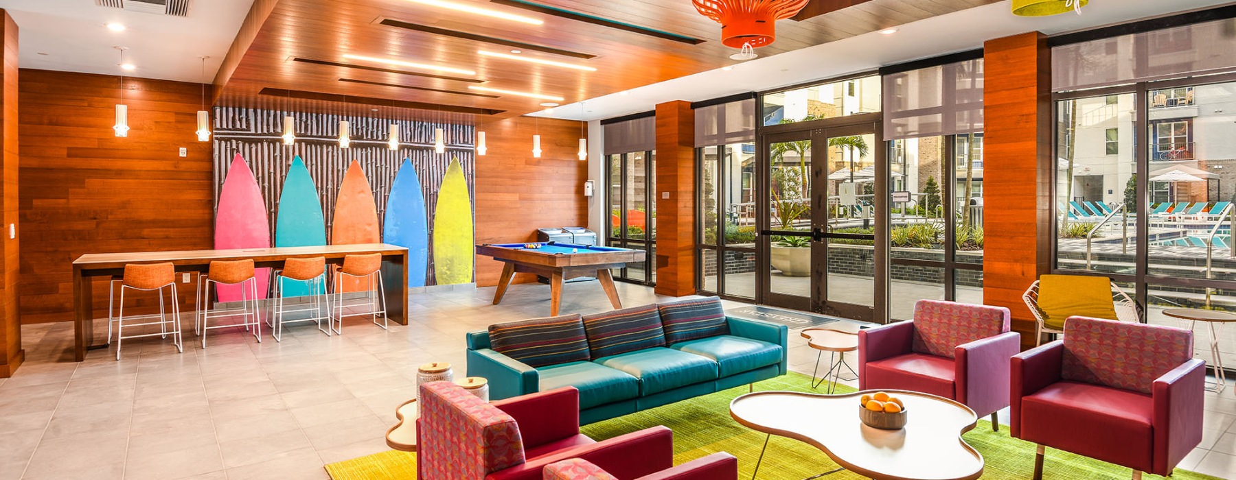a clubroom with a couch, tables and chairs